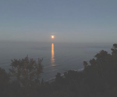 Image of a moonrise with moonlight reflected in the sea.